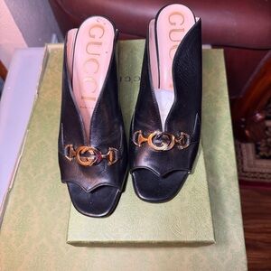 Gucci Black Mules with Gold Detailing